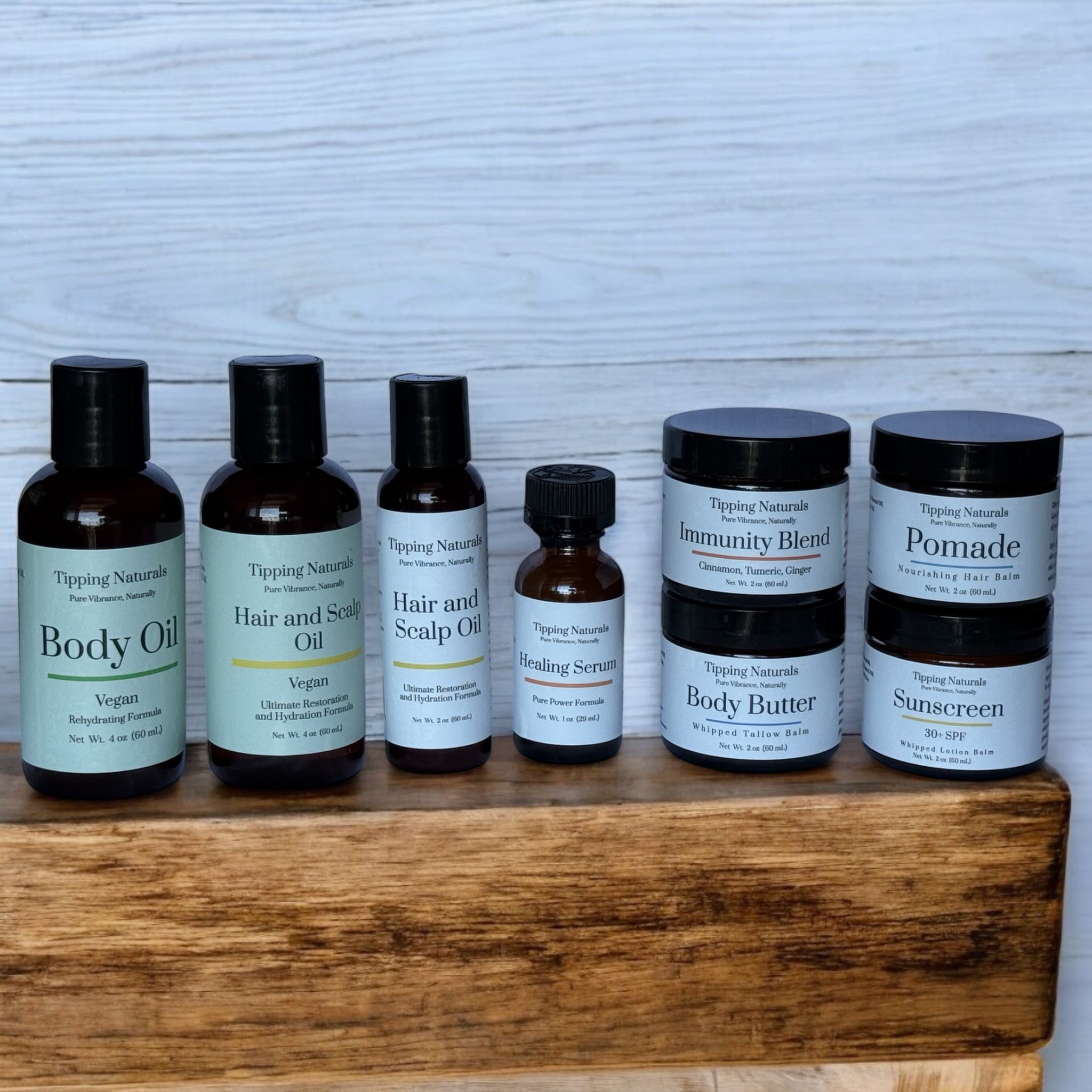 Tipping Naturals jars and bottles arranged on a wooden shelf